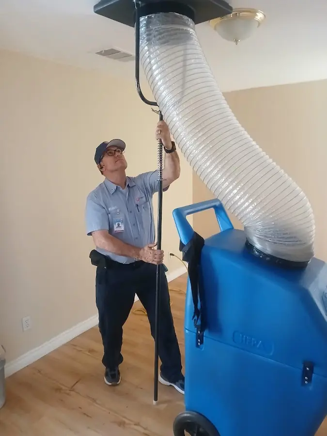 Furnace Tune-Up technician using HEPA equipment in Chaparral